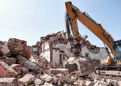 Heavy machine clearing off large rubble.